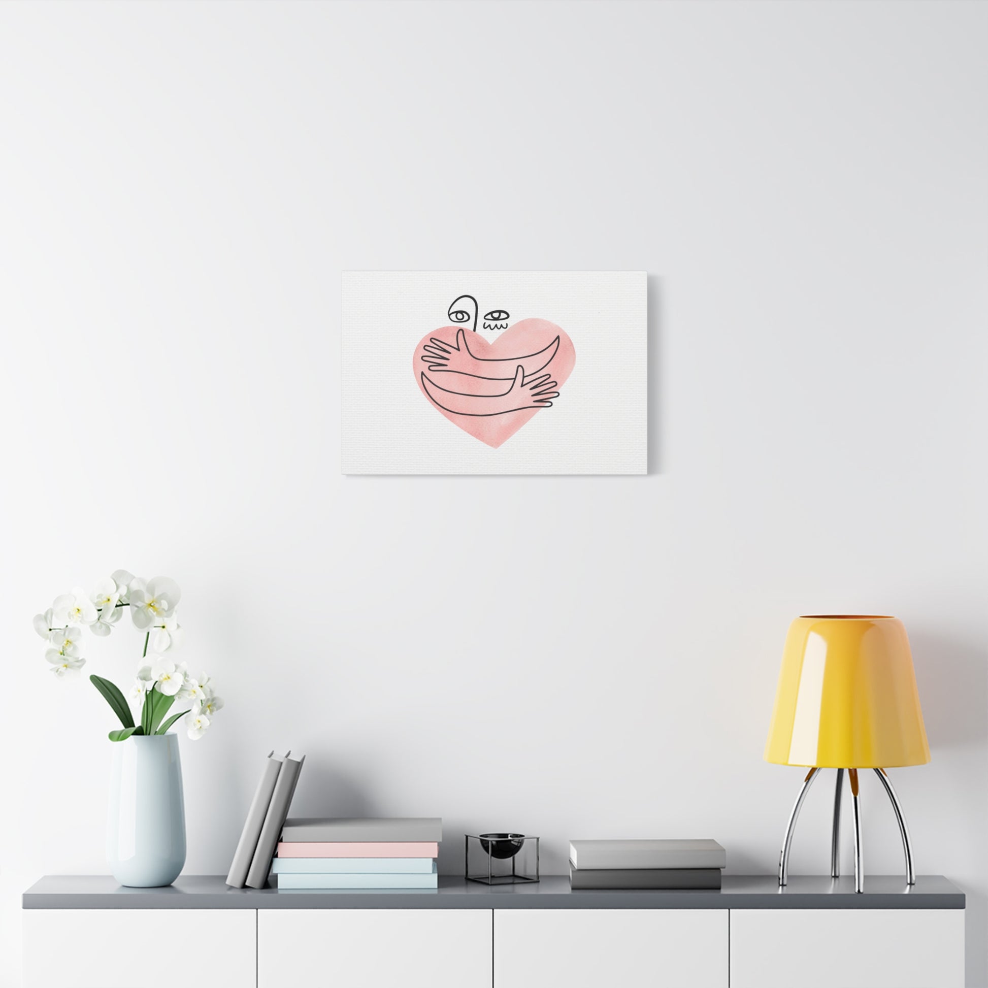 Heart-shaped artwork with a banana and smiley face on a white wall above a shelf with decor items.