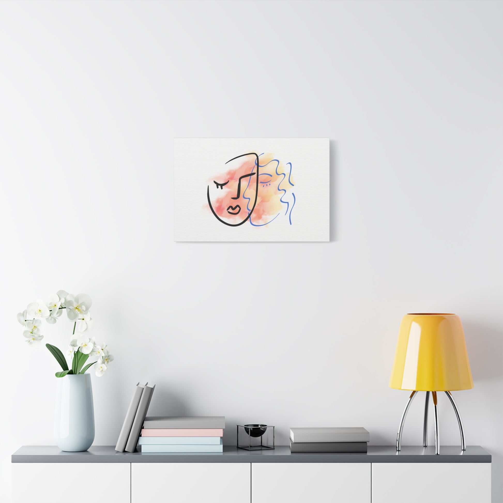 Abstract art print of a face on a white wall above a shelf with decor items.