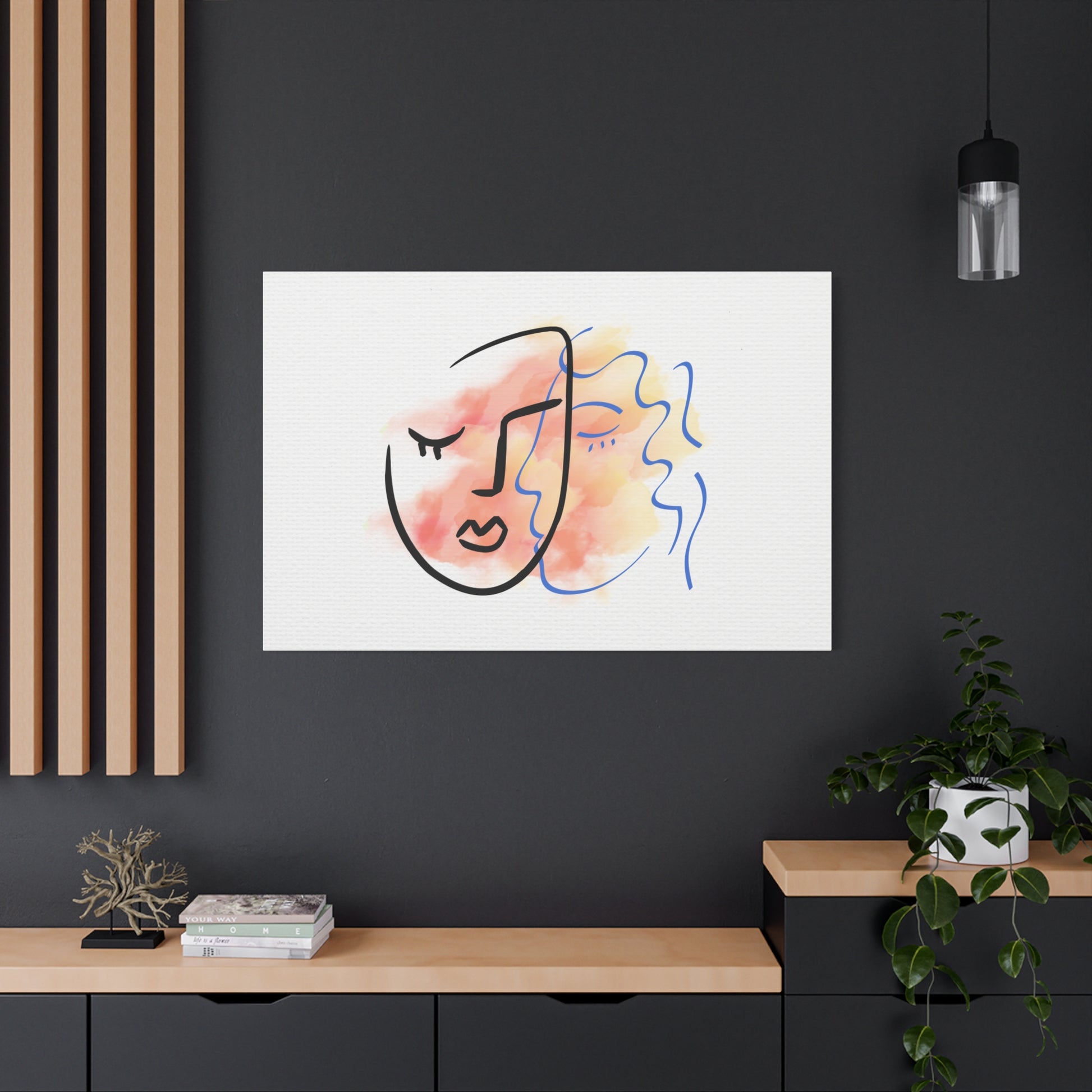 Abstract art print on a black wall with a wooden shelf and plant below.