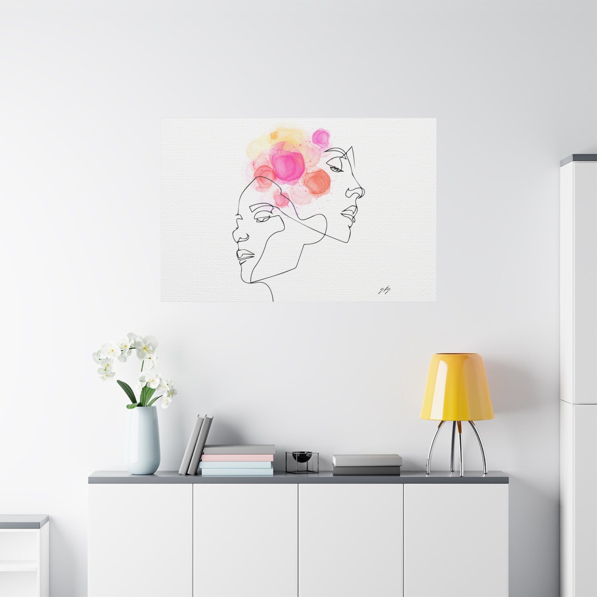 Modern interior with a wall art piece of a woman's face with flowers above it.