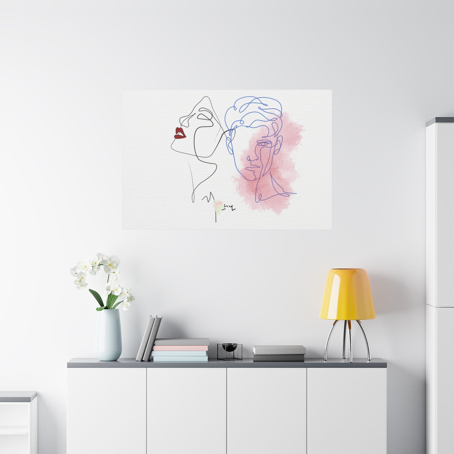 Modern interior with a minimalist line art painting of a woman's face on a white wall.