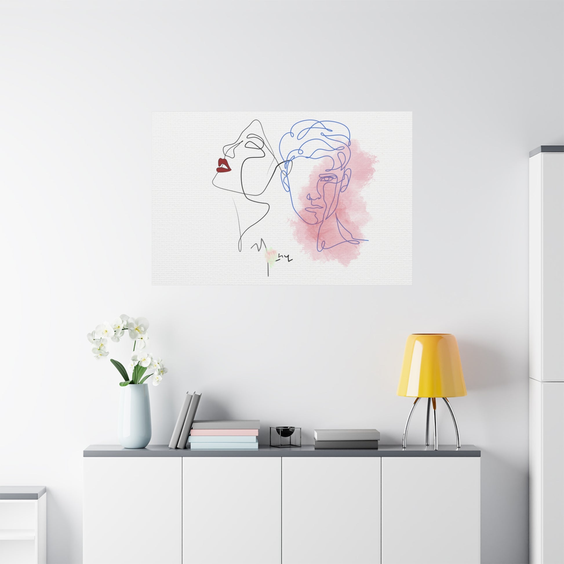Modern interior with a minimalist line art painting of a woman's face on a white wall.