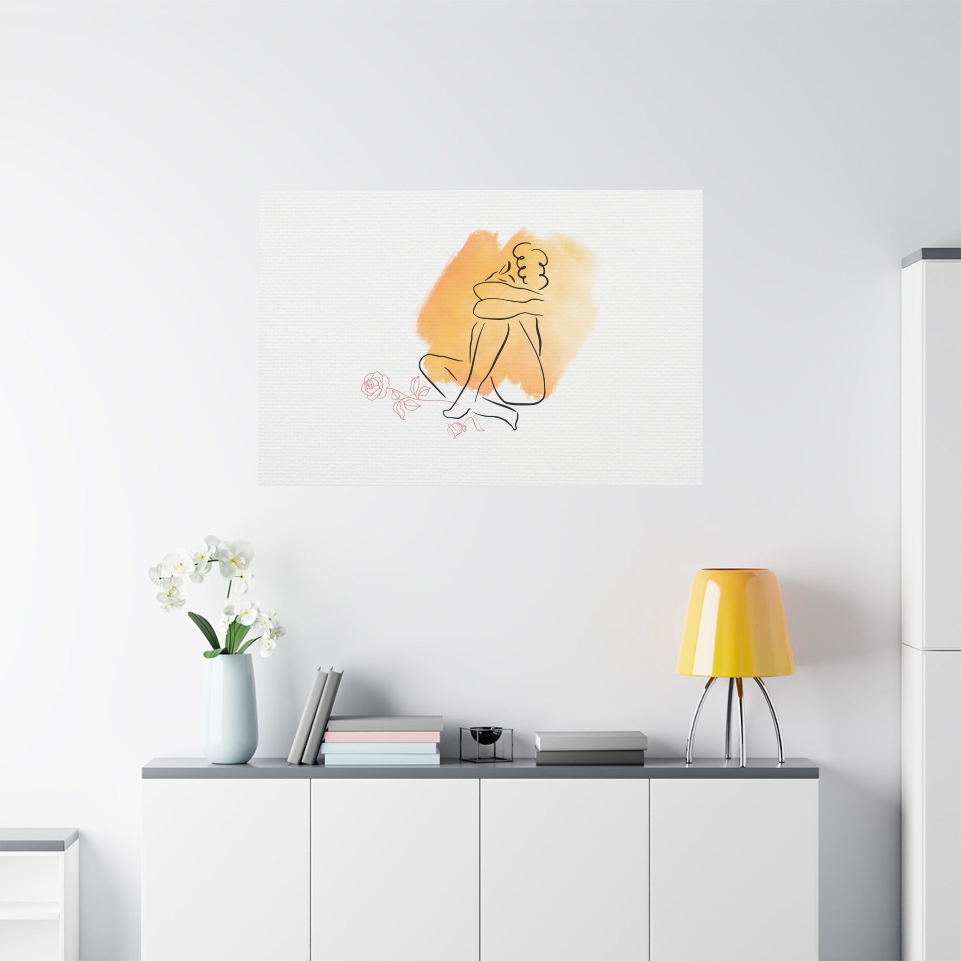 Minimalist interior with a yellow lamp, vase with flowers, and abstract art on a white wall.
